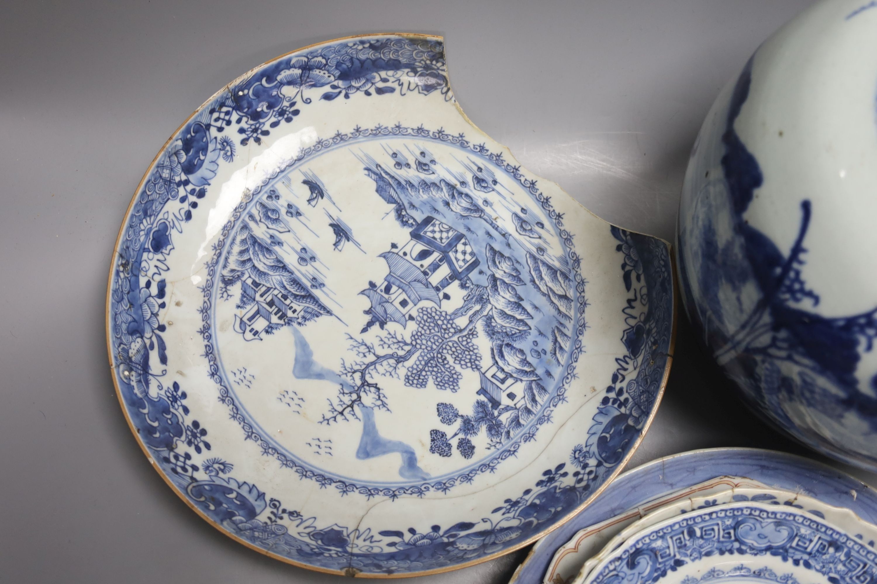 A group of 18th century Chinese export blue and white dishes, plates and a jar, the jar 21.5cm high